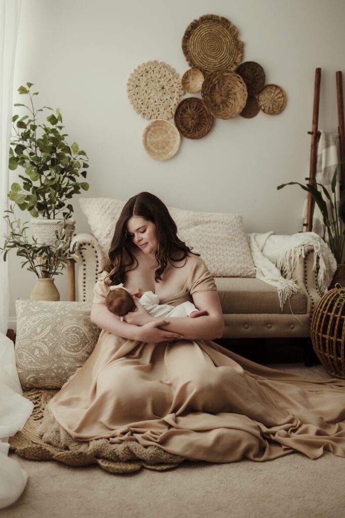 Newborn Photographer, a mother breastfeeds her baby at home
